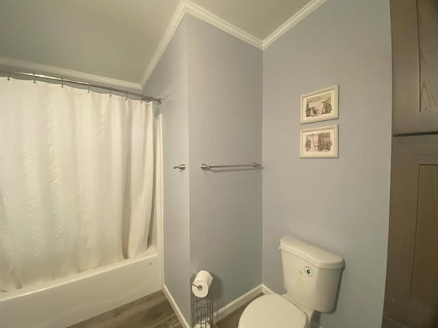 bathroom featuring ornamental molding, hardwood / wood-style flooring, toilet, and shower / tub combo with curtain