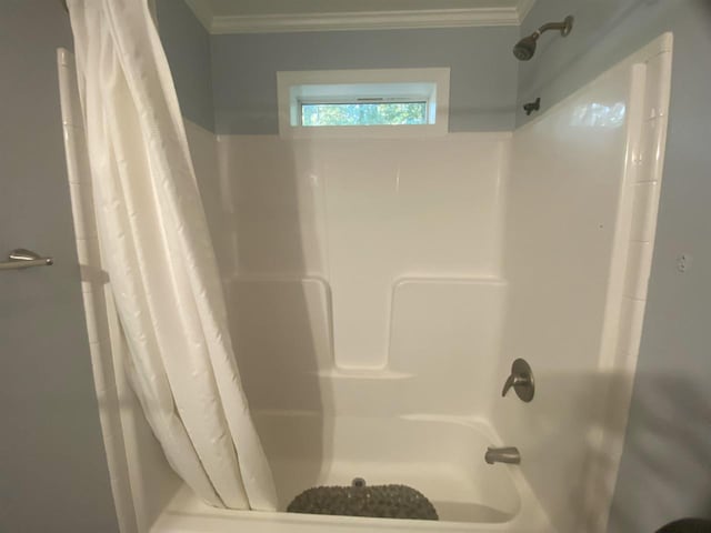 bathroom featuring shower / bath combo and ornamental molding