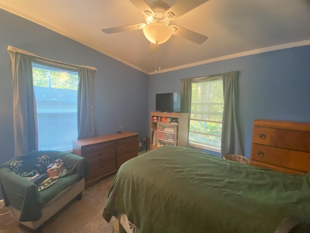 carpeted bedroom with ornamental molding, vaulted ceiling, and ceiling fan