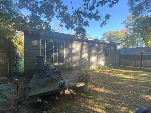 exterior space featuring a wooden deck and a yard