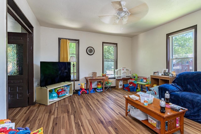 rec room featuring ceiling fan, hardwood / wood-style floors, and a healthy amount of sunlight