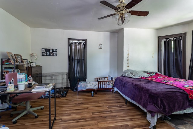 bedroom featuring ceiling fan and dark hardwood / wood-style flooring