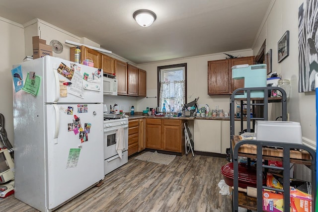 kitchen with ornamental molding, dark wood-type flooring, and white appliances