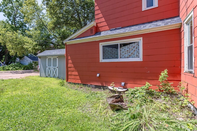 view of property exterior with a lawn and a shed