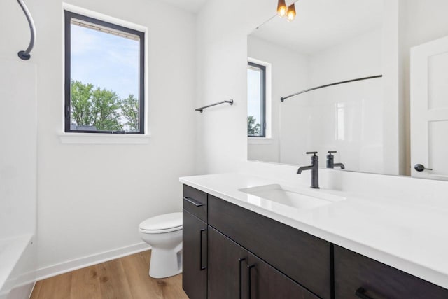 full bathroom featuring shower / bathtub combination, vanity, toilet, and hardwood / wood-style flooring