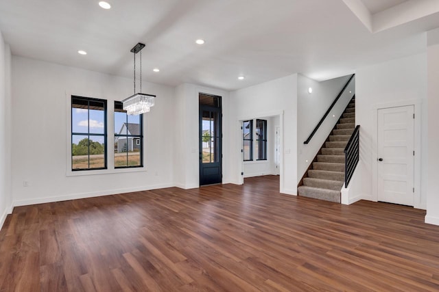 interior space featuring a chandelier and dark wood-type flooring