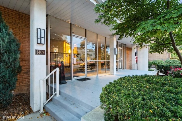 view of exterior entry with a porch