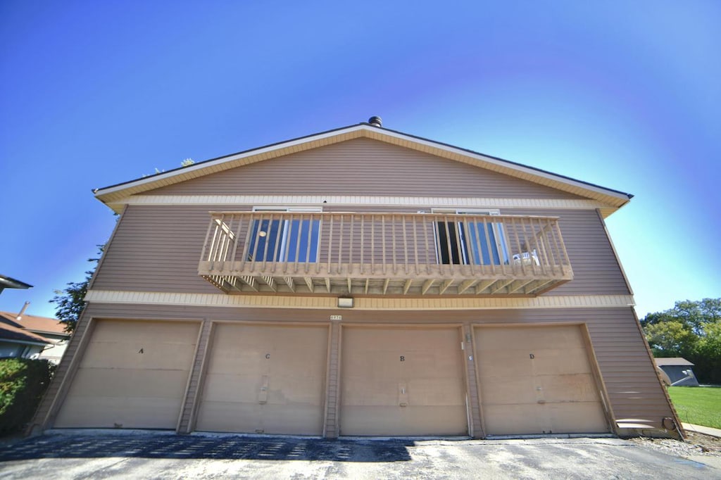 view of front of home featuring a balcony and a garage