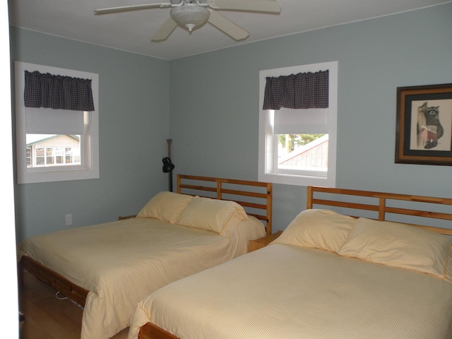 bedroom featuring multiple windows and ceiling fan