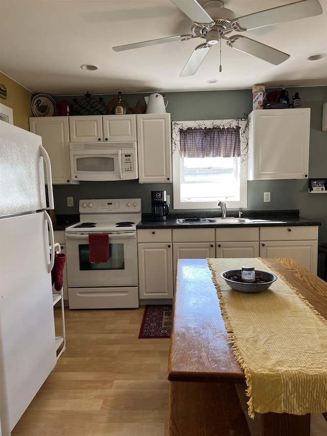 kitchen featuring white cabinets, white appliances, light wood-type flooring, ceiling fan, and sink