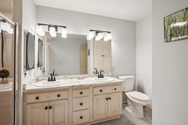 bathroom featuring vanity, toilet, and an enclosed shower