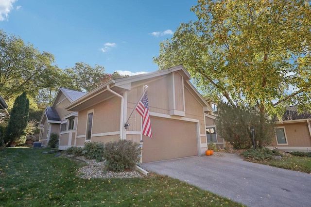 view of front of home with a garage and a front lawn