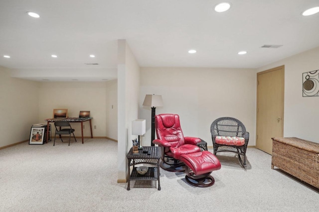 living area featuring light carpet