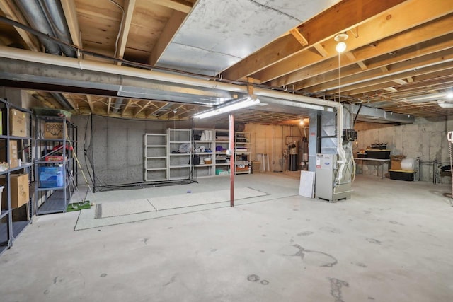 basement with water heater and heating unit