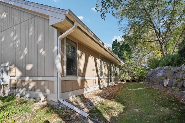 view of side of property with a lawn