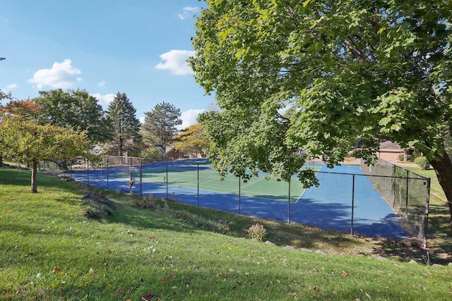 view of sport court featuring a lawn