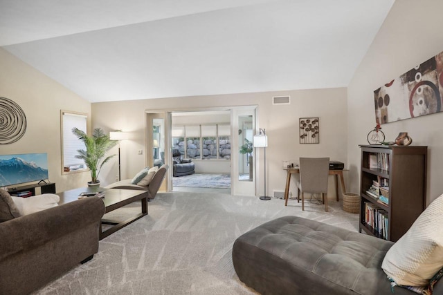 carpeted living room featuring lofted ceiling