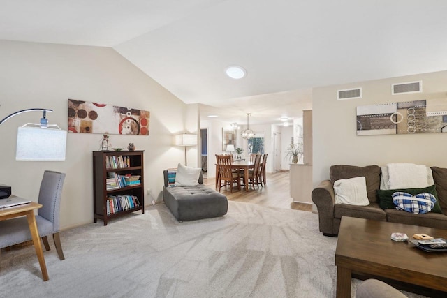 living room featuring vaulted ceiling and light hardwood / wood-style floors