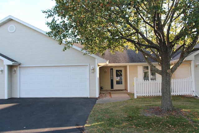 ranch-style home featuring a front yard and a garage