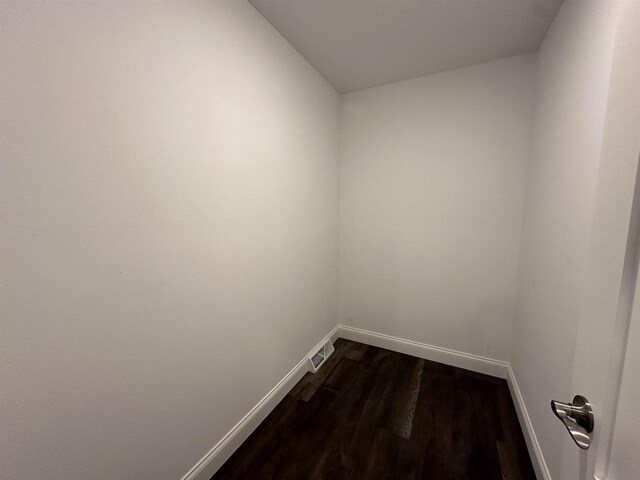 empty room with dark hardwood / wood-style flooring