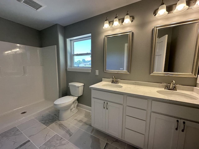 bathroom with toilet, vanity, and walk in shower