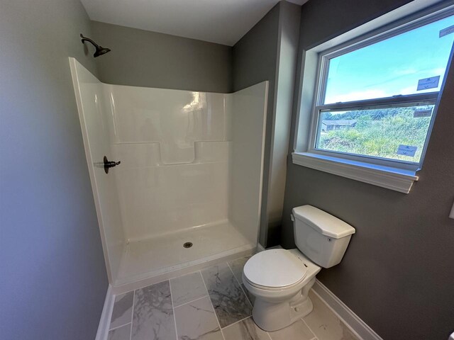 bathroom with toilet and walk in shower