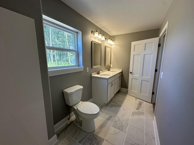 bathroom featuring vanity and toilet