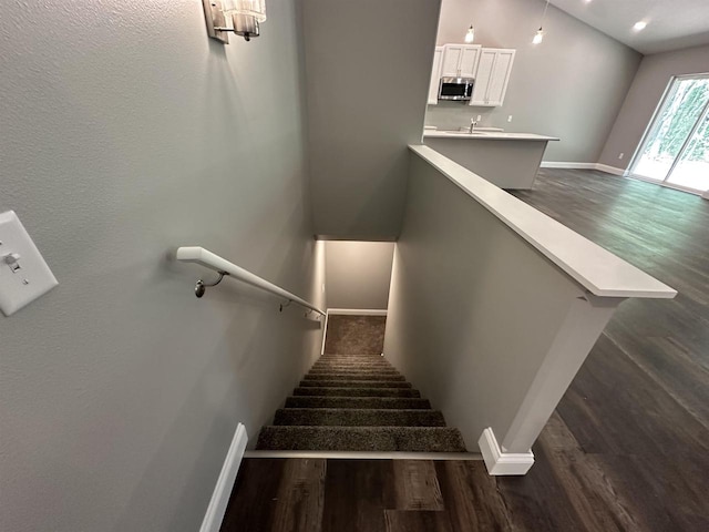 stairs with sink and wood-type flooring