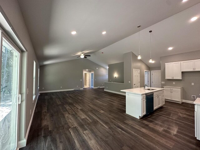 kitchen with ceiling fan, black dishwasher, dark hardwood / wood-style floors, an island with sink, and white cabinets