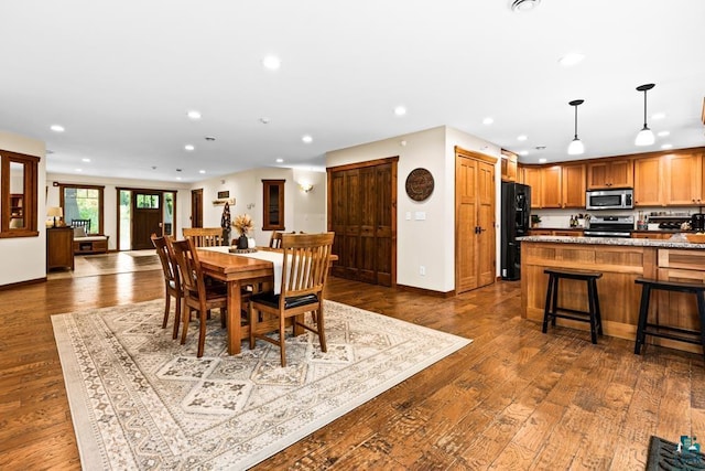 dining space with dark wood-type flooring