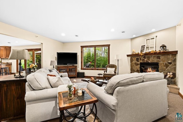 carpeted living room with a fireplace