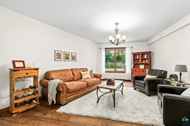 living room featuring a notable chandelier and dark hardwood / wood-style floors