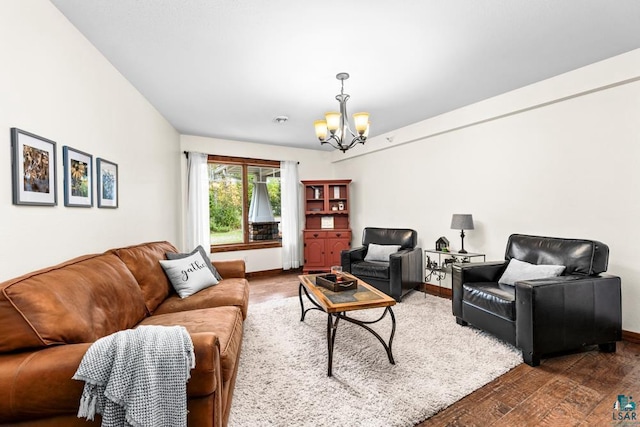 living room featuring an inviting chandelier and dark hardwood / wood-style floors