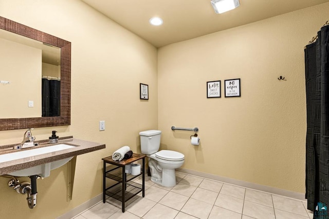 bathroom with toilet and tile patterned floors