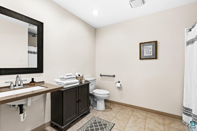 bathroom with sink, toilet, and tile patterned floors