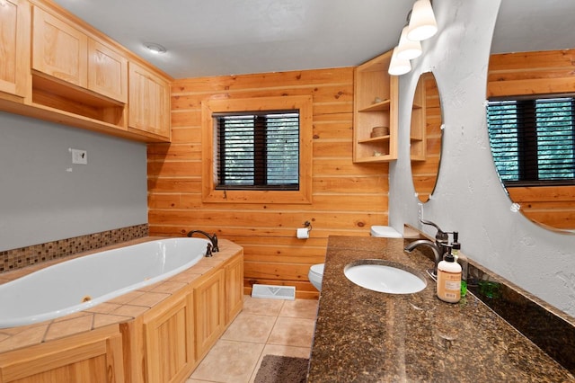 bathroom with a healthy amount of sunlight, wood walls, a tub, and toilet