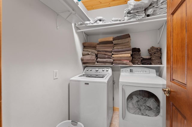 laundry room with separate washer and dryer and light tile patterned flooring