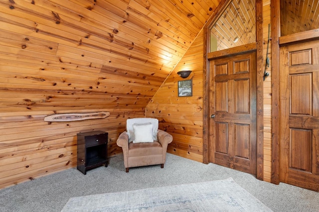 living area with wooden ceiling, carpet, lofted ceiling, and wooden walls