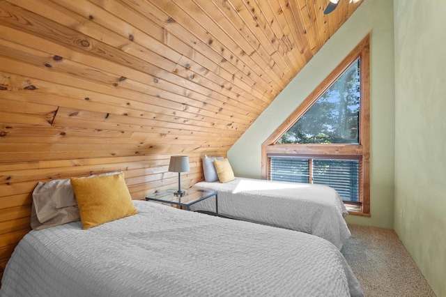 bedroom featuring carpet floors, wooden walls, wood ceiling, and vaulted ceiling