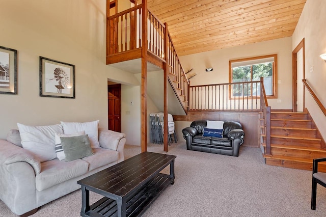 carpeted living room with wood ceiling and high vaulted ceiling