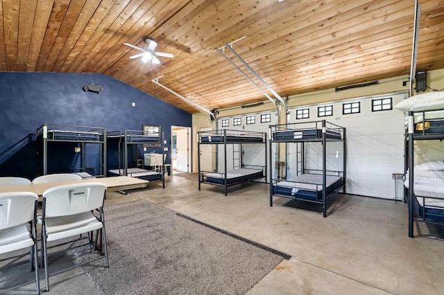 bedroom with high vaulted ceiling, wood ceiling, multiple windows, and concrete floors