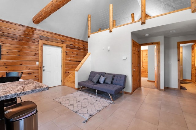 tiled living room with high vaulted ceiling, wooden walls, and beamed ceiling