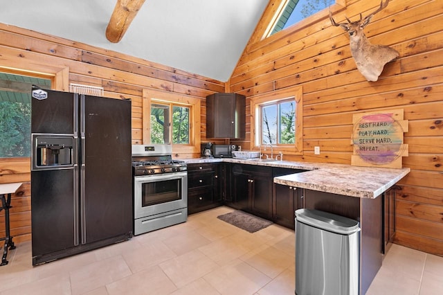 kitchen with wood walls, black refrigerator with ice dispenser, and gas range