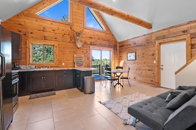 kitchen with wooden walls, plenty of natural light, beam ceiling, and high vaulted ceiling