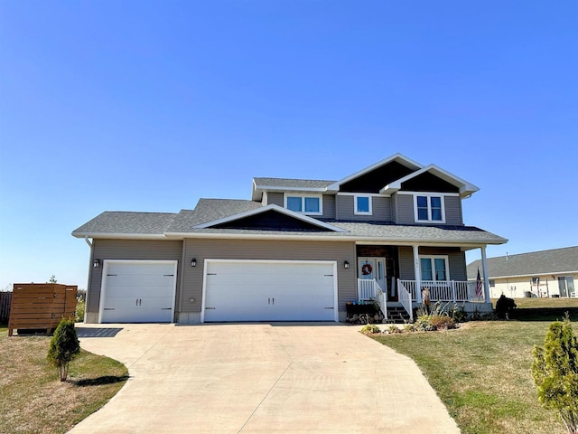 view of front of property featuring a front lawn, a porch, and a garage