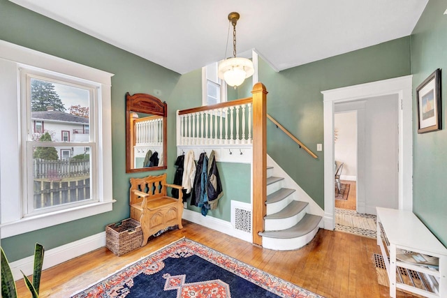 interior space featuring hardwood / wood-style flooring and a notable chandelier