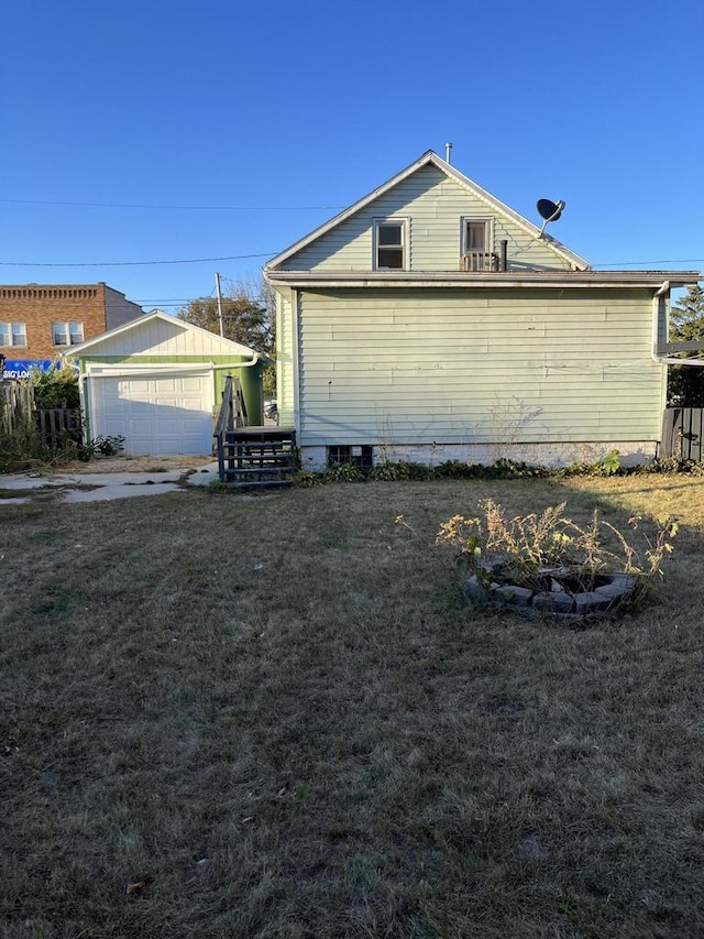 view of side of property with a lawn and an outdoor fire pit