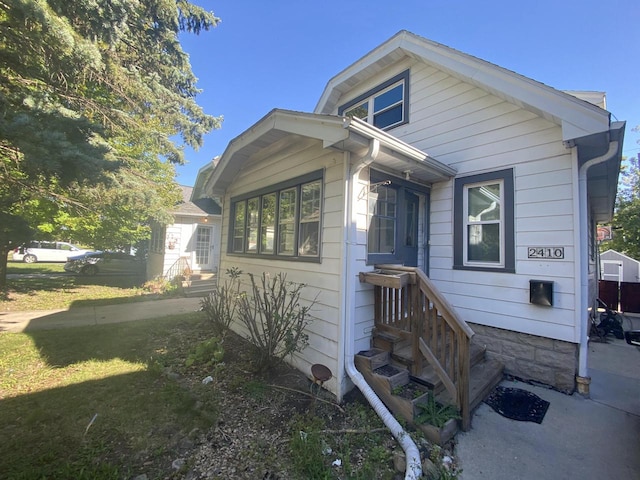 view of side of home featuring a yard