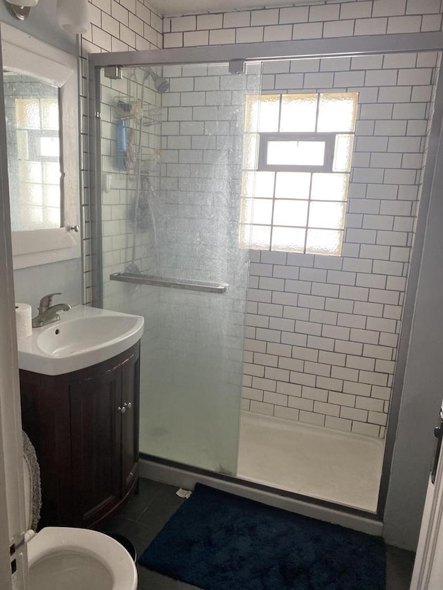 bathroom with vanity, toilet, tile patterned floors, and an enclosed shower