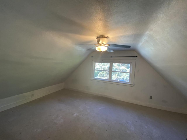 additional living space with ceiling fan, a textured ceiling, lofted ceiling, and carpet